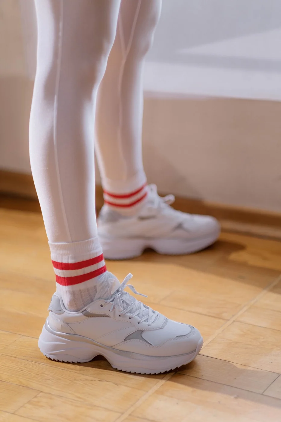 Opaque pale tights worn with sneakers