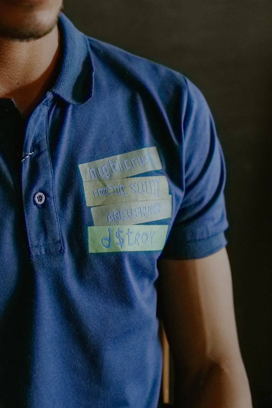 Close-Up of Blue Polo Shirt with Text Design