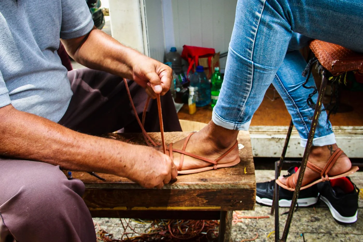 Leather sandals being fitted to the foot
