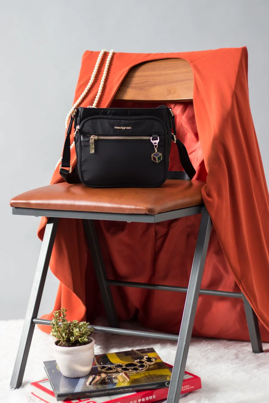Black crossbody bag resting on a chair