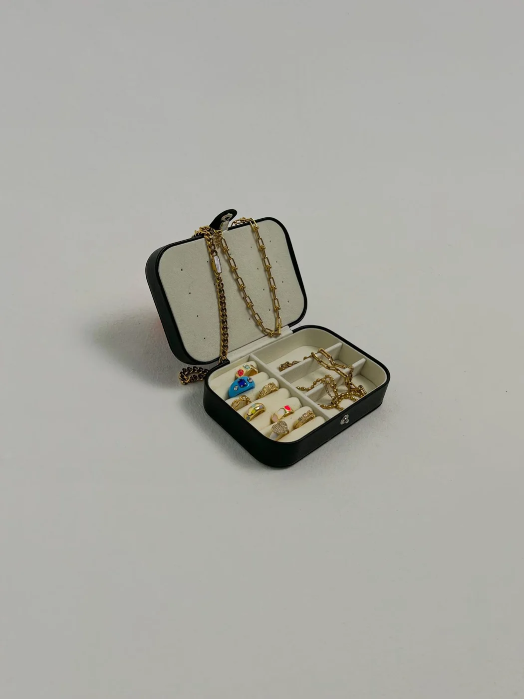 Jewelry box holding rings and a necklace