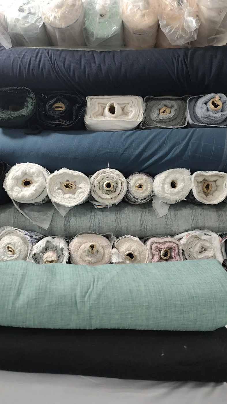 Colorful fabric rolls stacked in a textile shop