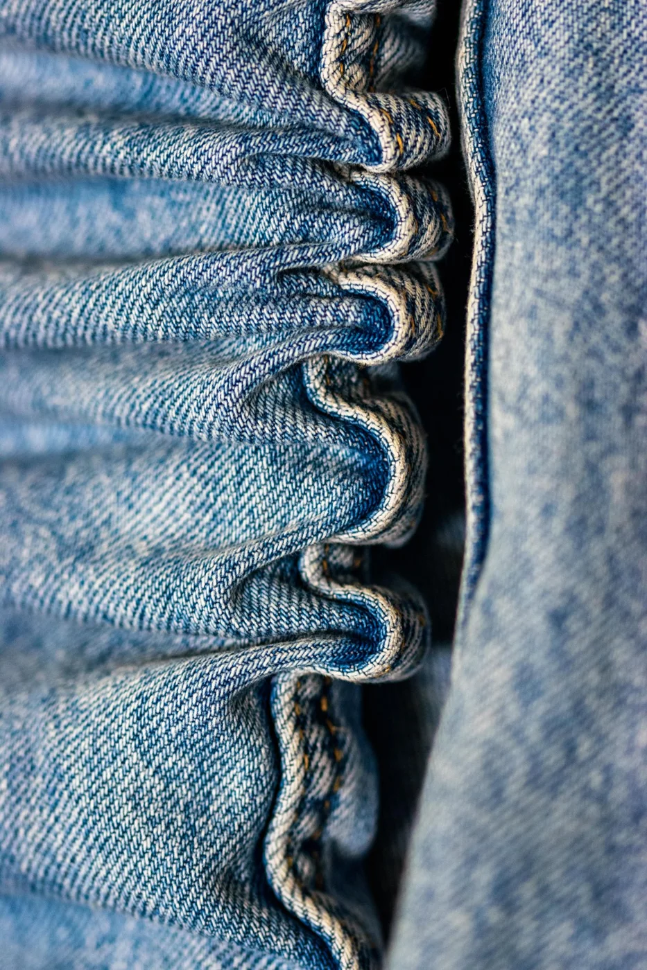 Close detail of a denim waistband seam
