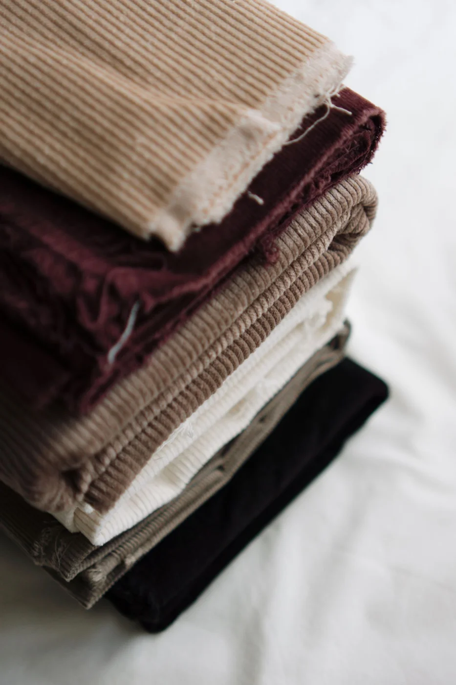 Stack of Multicolored Corduroy Fabrics Close-up