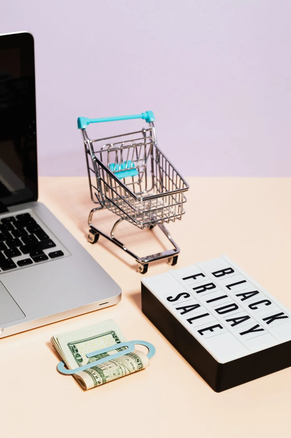 Sale sign with a small shopping cart and money