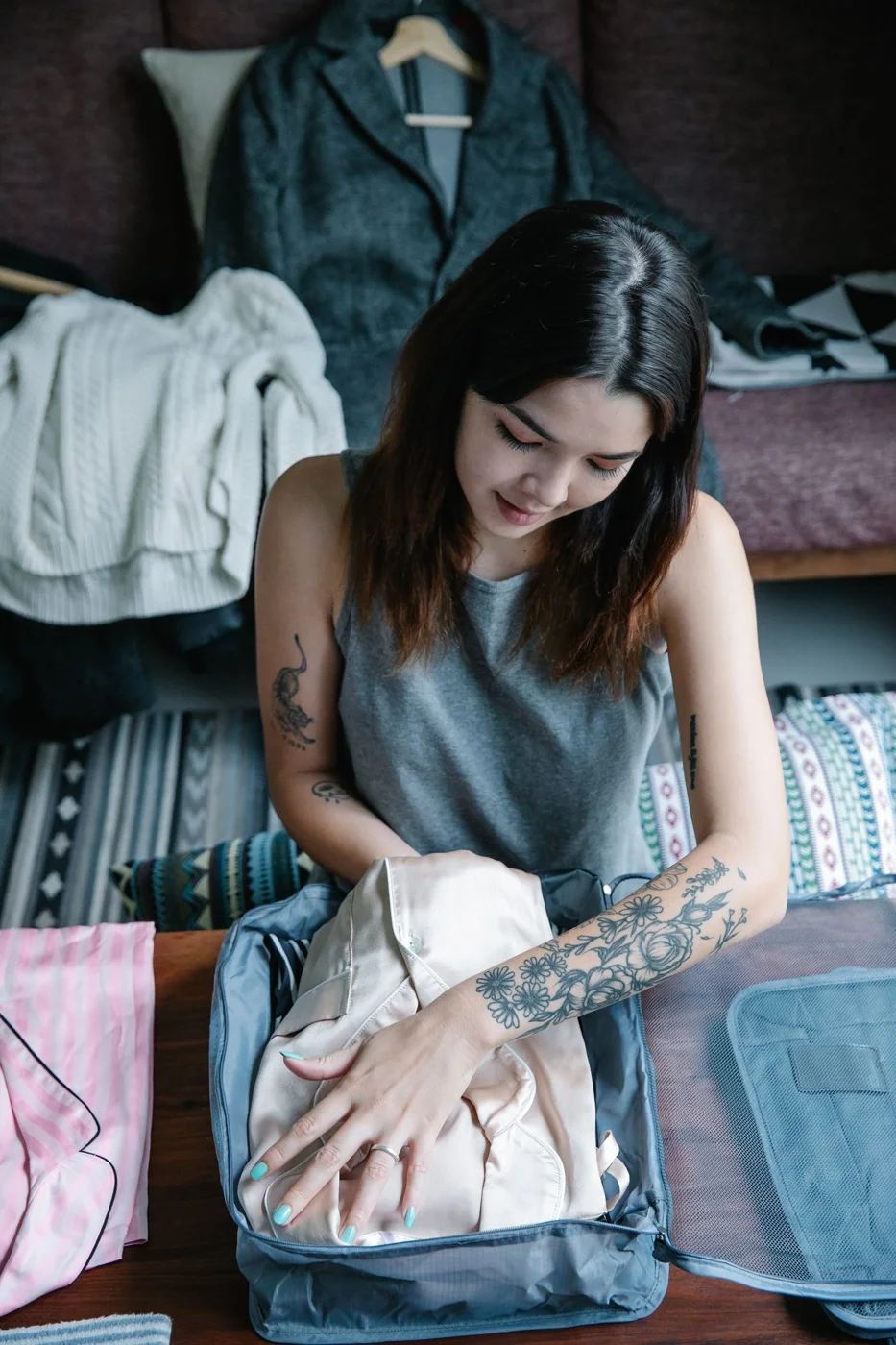 Woman Putting Clothes in a Bag